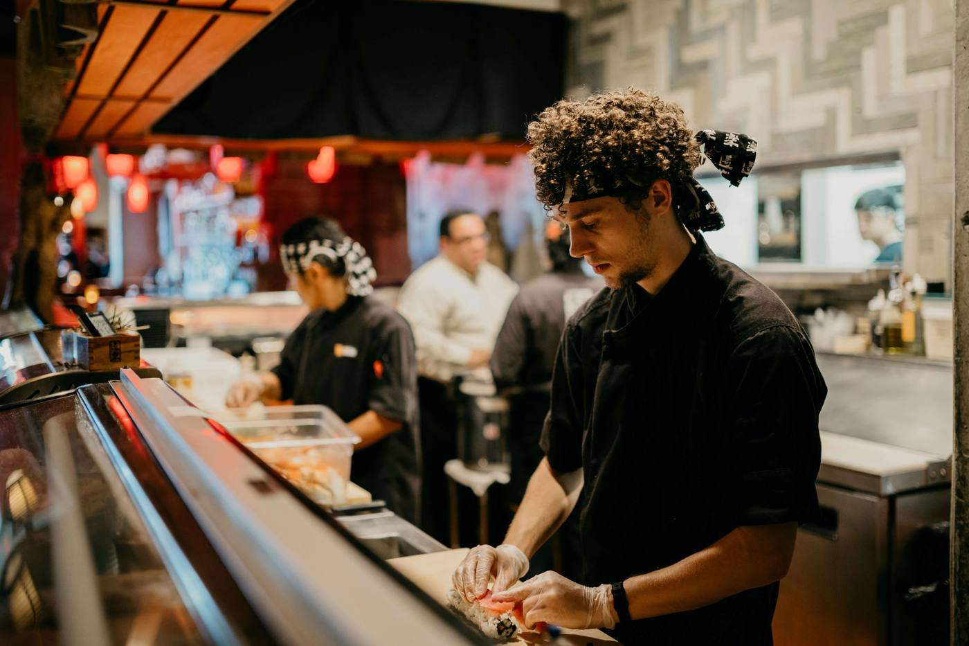 Chefs working the line in a busy open kitchen