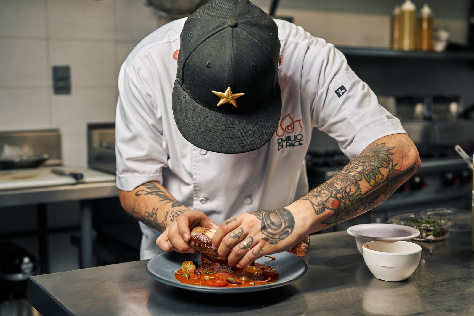 Head chef plating a dish at the pass