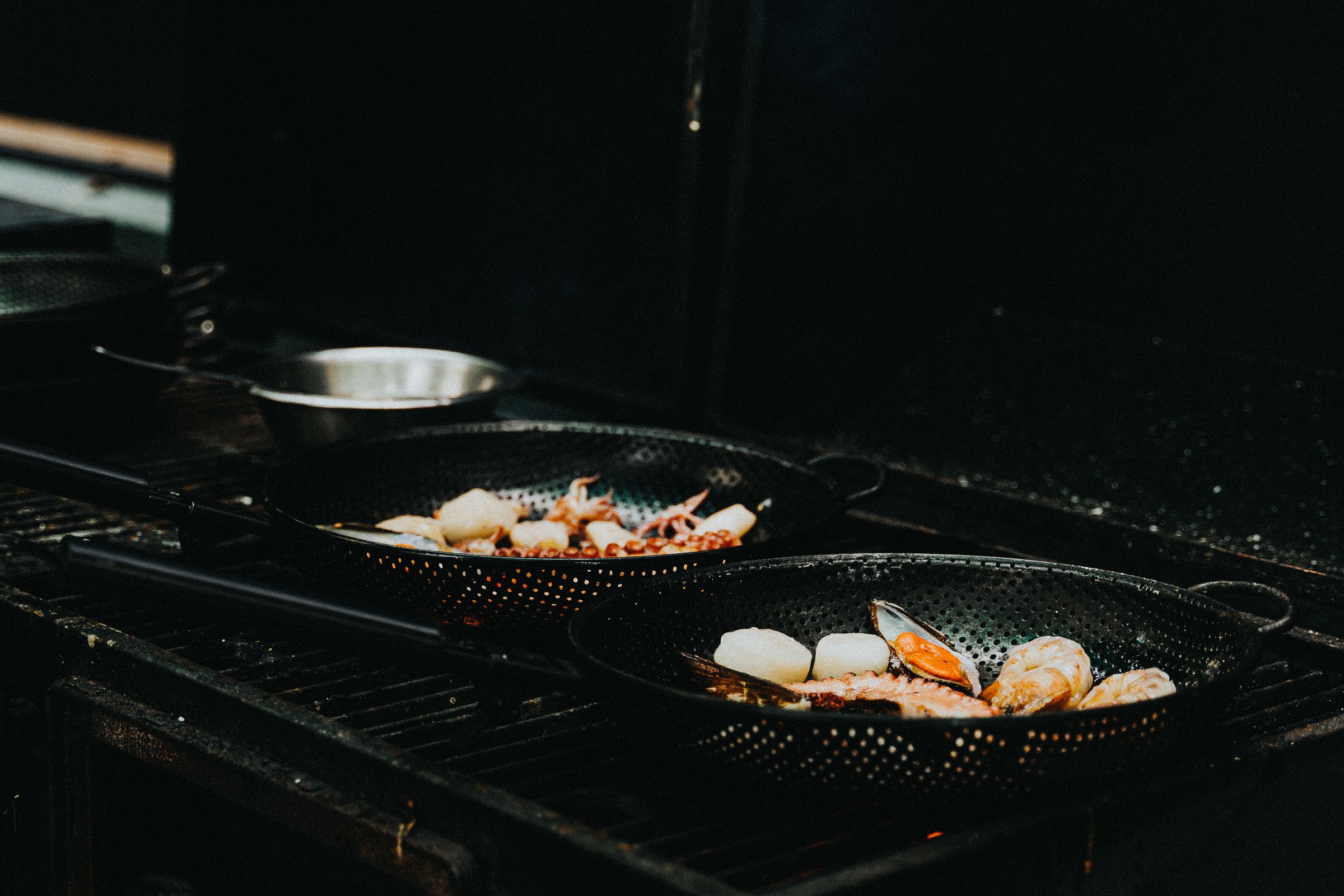 Seafood on the grill in a busy kitchen