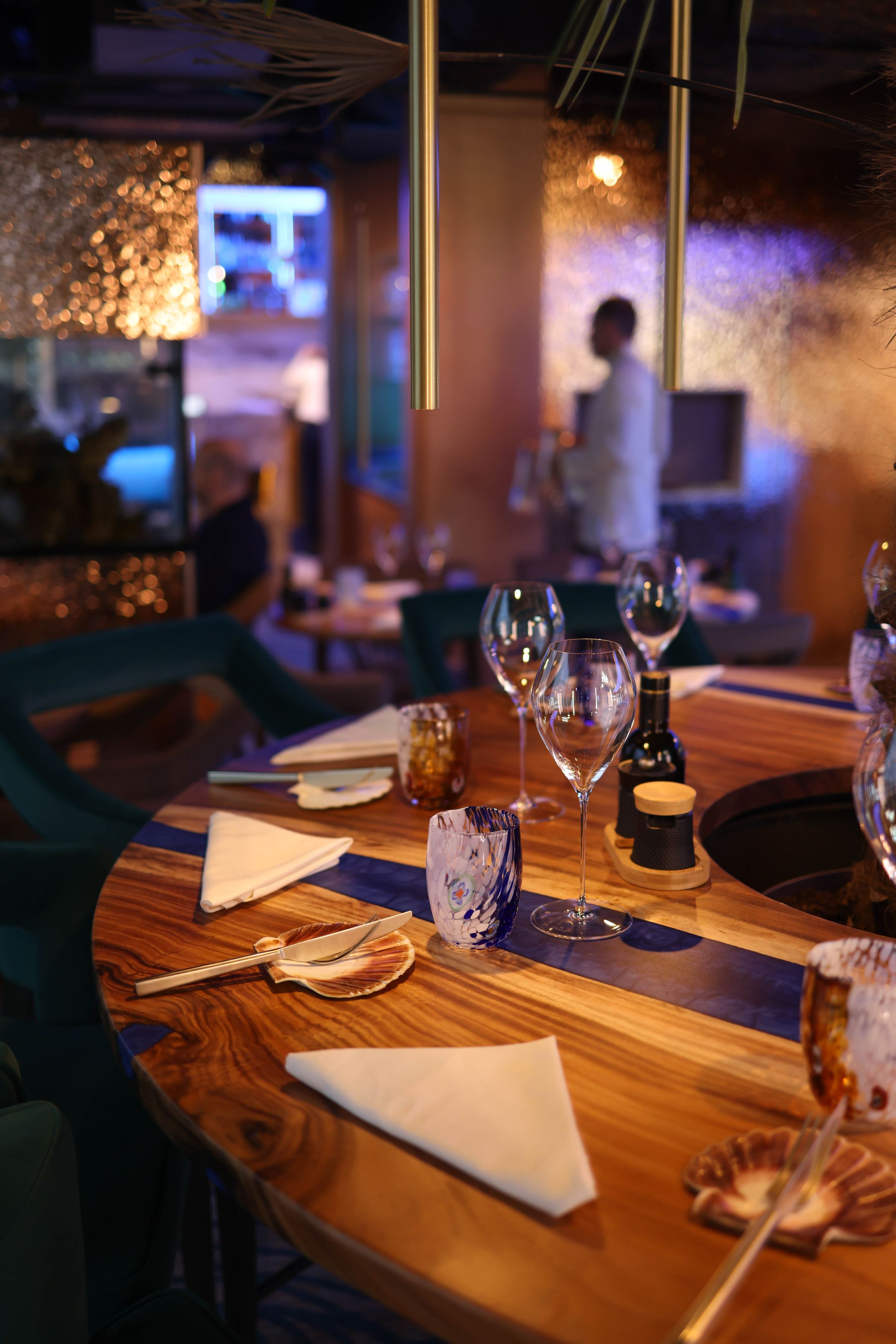 A table set for dinner service in a warmly lit restaurant