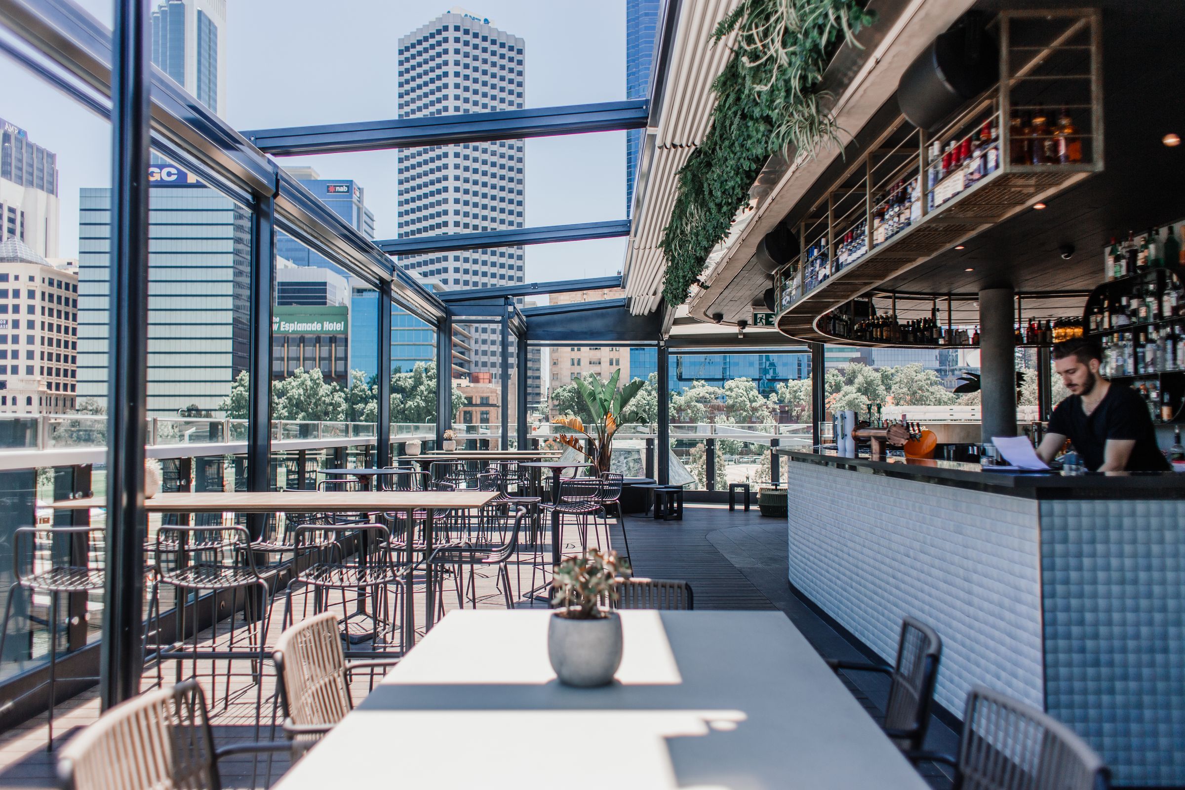 A rooftop bar and terrace looking out over the city