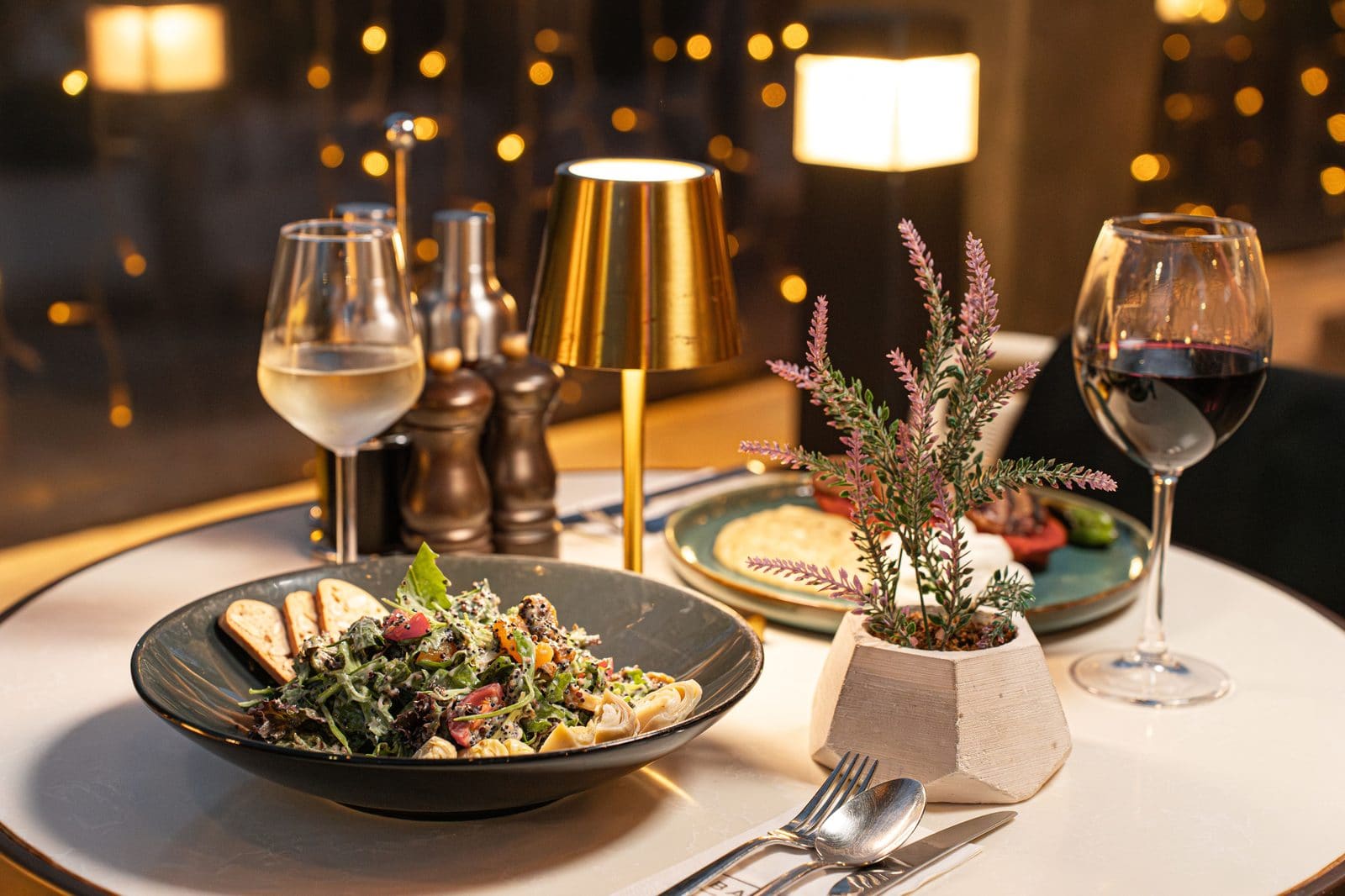 Elegant evening table setting with wine and a shared plate at a Melbourne venue