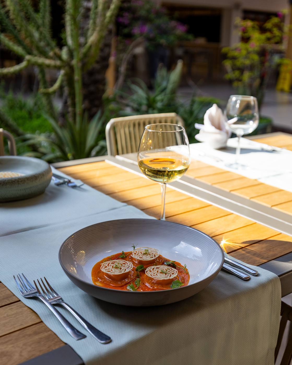 A table set with glassware and a plated starter