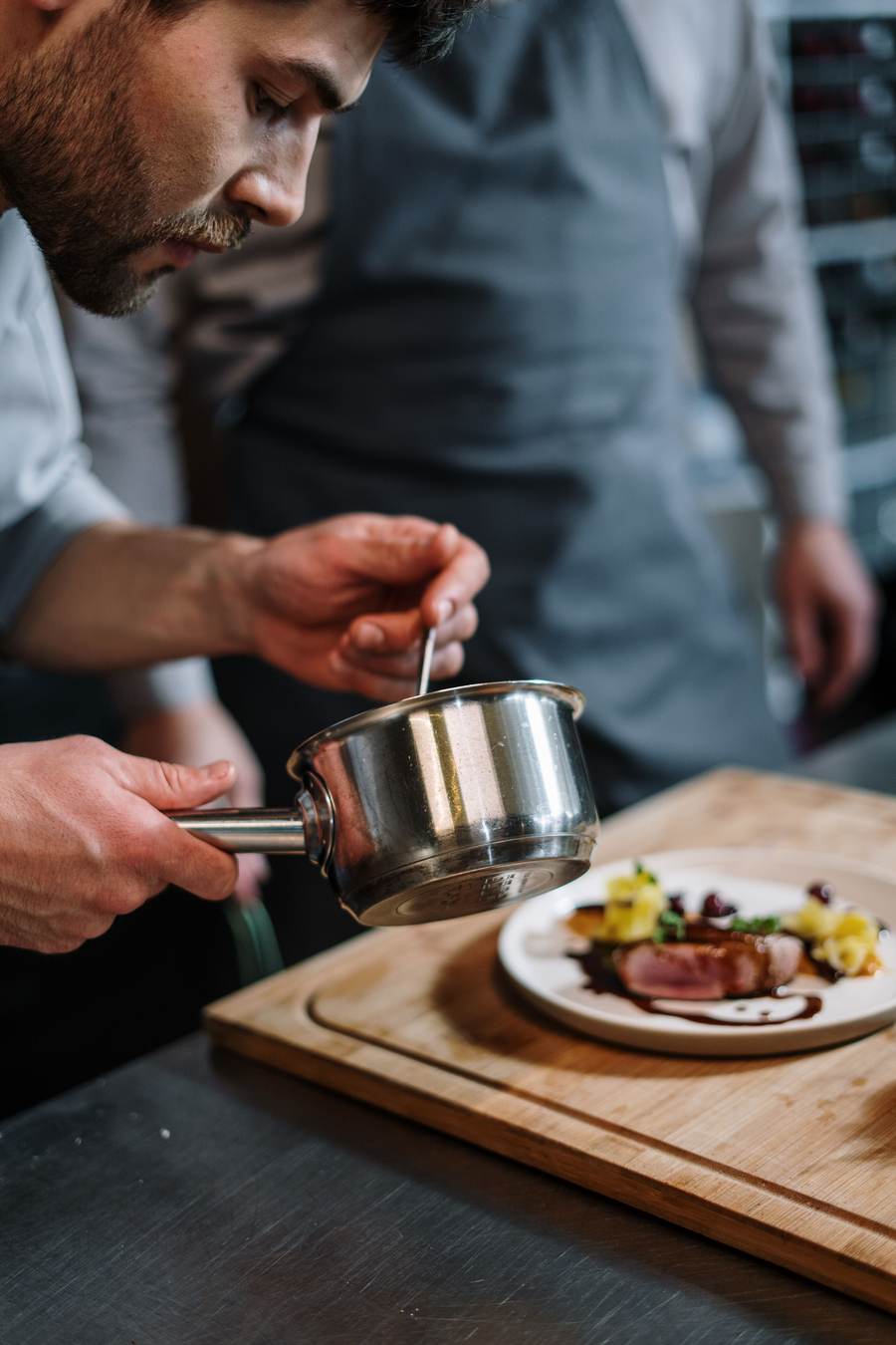 Chef reaching for a pan on the stove