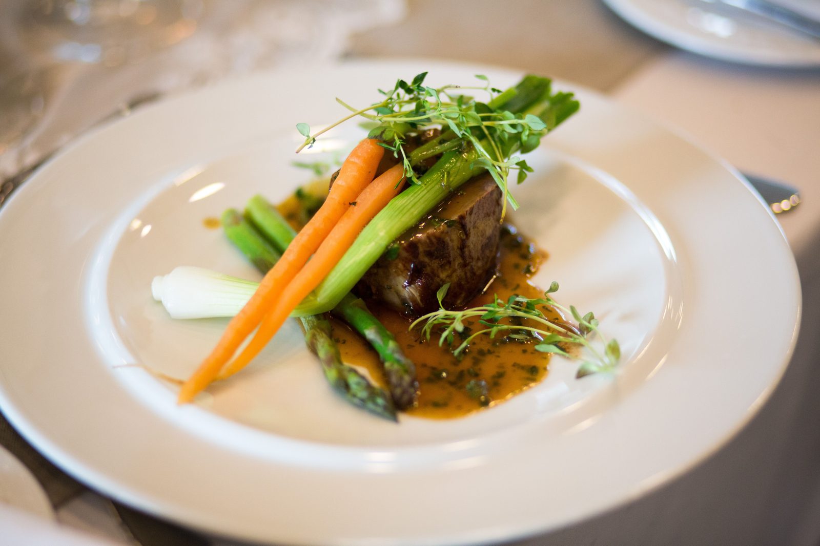 A plated main course with seasonal vegetables