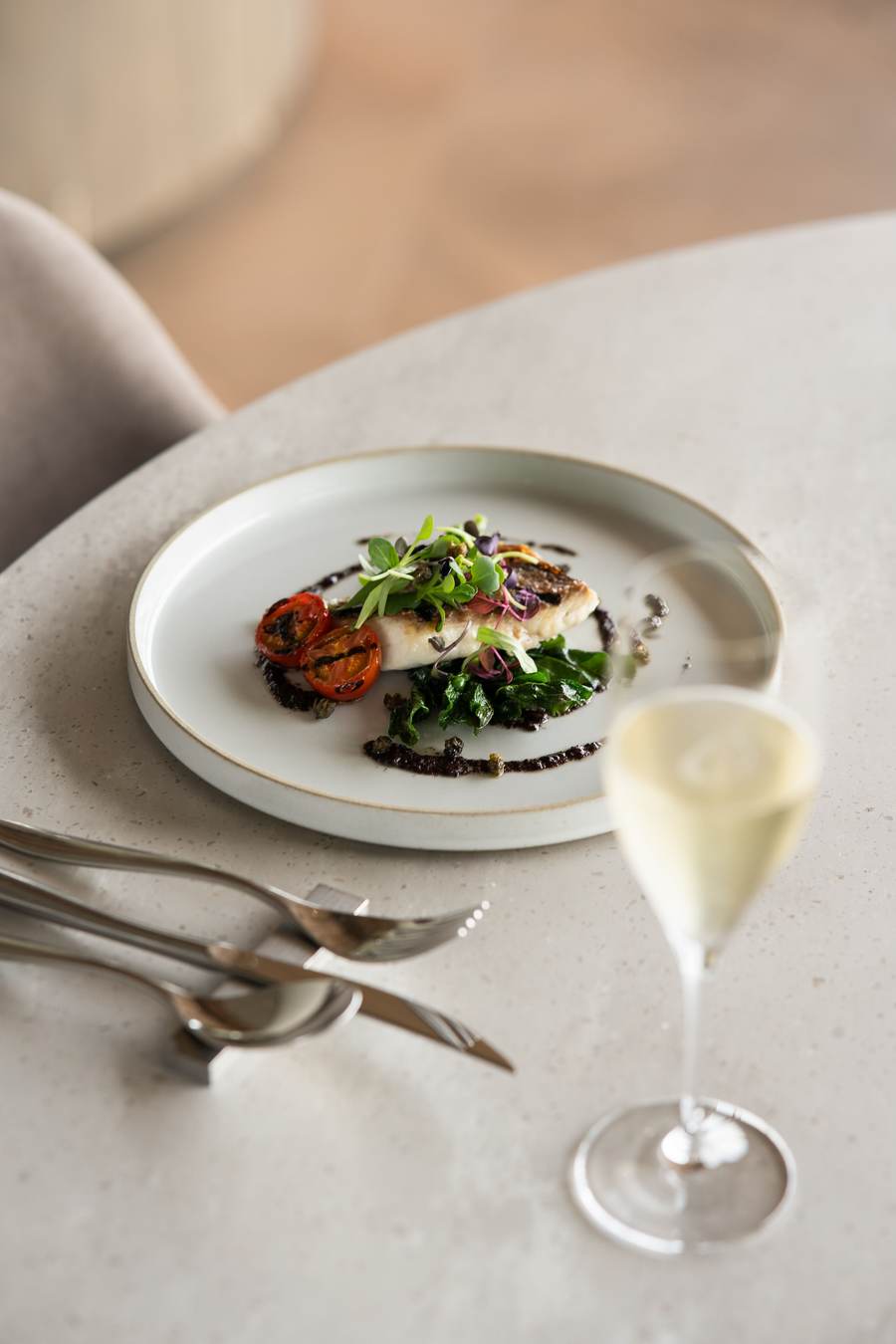A plated dish served with a glass of sparkling wine