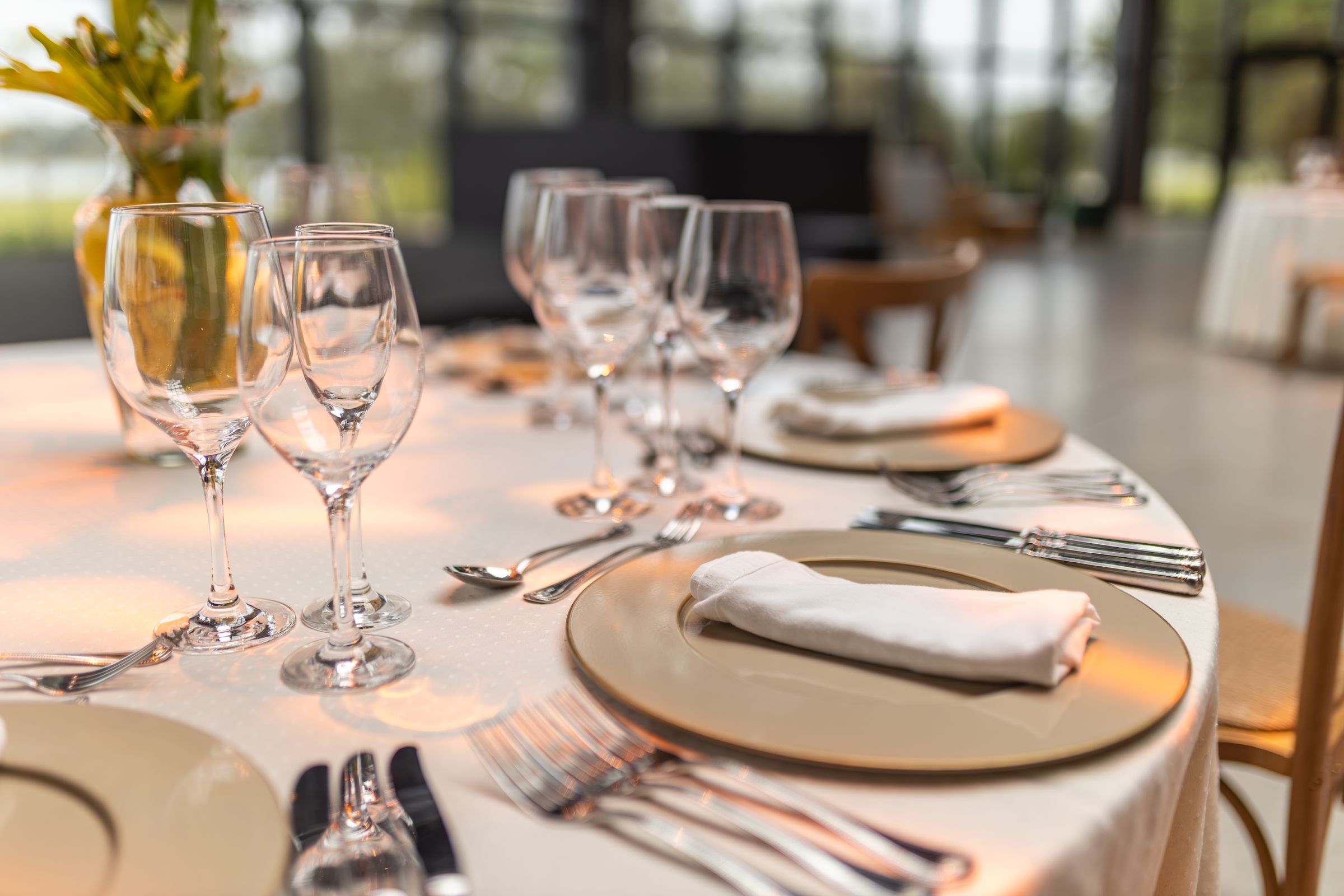 A set dining table with glassware in a bright restaurant
