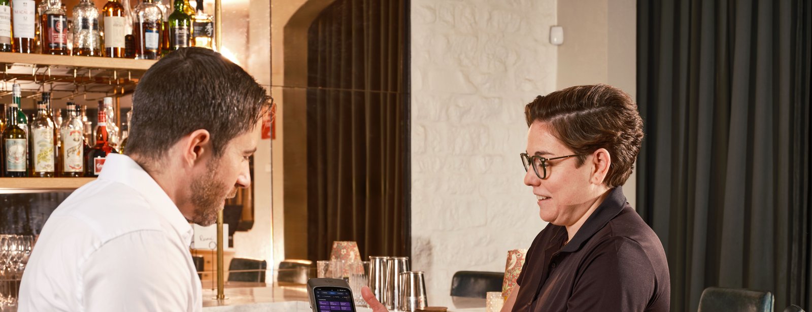 Venue manager at the bar talking with a colleague